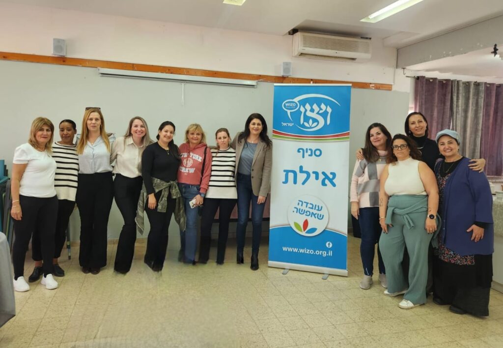 מירה מינס יחד עם צוות המתנדבות בסניף אילת והעובדות שפונו ממקום מגוריהן ושוהות בעיר והמפקחת טלי פרץ